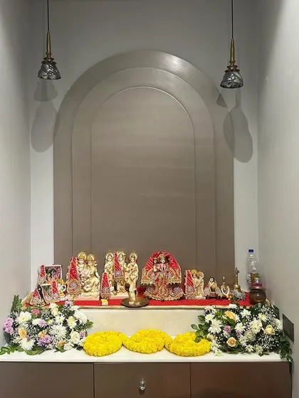 A simple yet elegant home mandir decoration for a small gathering. We used fresh flower bouquets and marigold garlands to adorn the sacred space without overwhelming it.