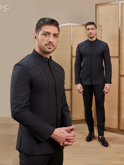 This timeless black bandhgala is defined by its sharp lines and endless possibilities. The clean silhouette and subtle shoulder detailing make it a powerful statement of minimalist luxury.