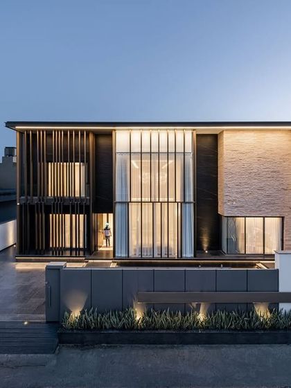 The exterior of the Silhouette residence showcases a masterful blend of privacy and artistry. The screens offer seclusion without sacrificing light, while the overall structure presents a clean, contemporary profile.