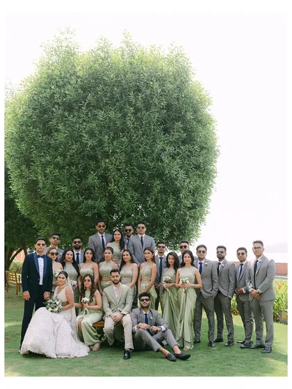 A large group portrait of the entire wedding party. The coordinated outfits and the grand scale of the photo make it a powerful memory of everyone who shared in their special day.