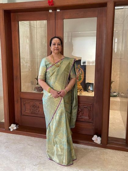 Our client Keerthana looks splendid in a rich silver-blue floral brocade saree.