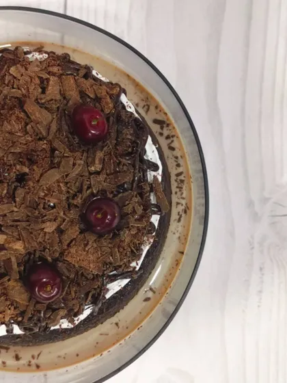 My take on a classic, this is the Black Forest Tres Leches. It features a rich chocolate sponge soaked in my signature milk blend, layered with cream, and topped with chocolate shavings and fresh cherries.
