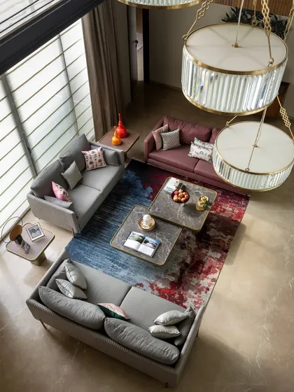 An overhead view of the living room, emphasizing the beautiful abstract rug that acts as an anchor for the entire seating arrangement. We often use statement rugs as a foundation for our color and texture palettes.