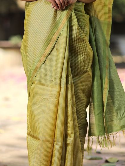 A closer look at the checked pattern of our Genda Phool Kosa Silk Saree. The combination of colors and the natural sheen of the silk make it a truly special piece.