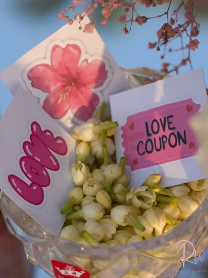 A close-up of the "love coupons" and jasmine buds, showing the level of detail in the personalized wedding favors.