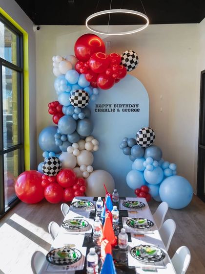 A wide shot of the bright and modern race car party corner, perfect for a small celebration.