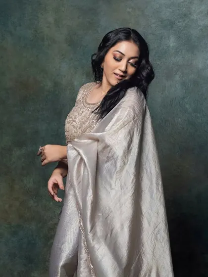 A candid, happy moment from the shoot. Her soft glam makeup looks beautiful and natural, with a focus on her expressive eyes.