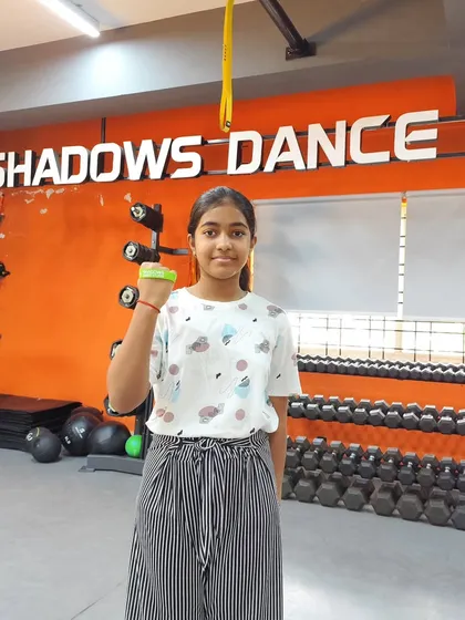 We believe in celebrating progress. Samriddhi proudly shows off her Green Band, an award for mastering our intermediate-level curriculum. This is a key part of how we track growth and motivate our students.