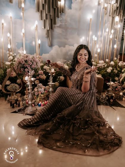 A serene portrait of the bride surrounded by flowers and candles at her Mehendi ceremony.