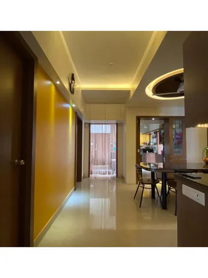 An identical view of the hallway, showing how lighting and color can transform a simple circulation space.
