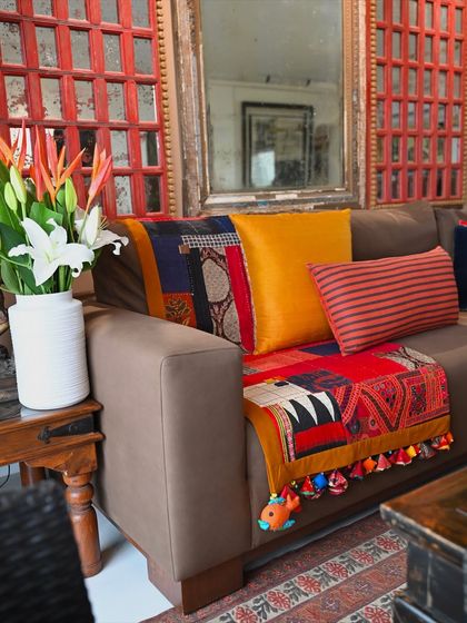 The vibrant colors of the scrap quilt bring warmth and energy to this living space. Each of these improv pieces is a time-consuming joy to create.