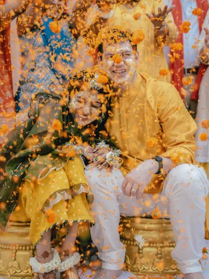 A shower of marigold petals marks the peak of the Haldi celebration. This frame is a whirlwind of color, emotion, and energy, perfectly capturing the festive spirit as the couple is blessed by their loved ones.