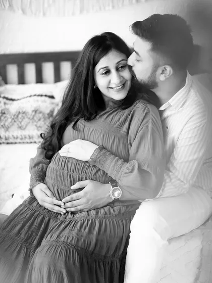 A candid black and white photo of a couple sharing a sweet moment on our studio bed set.