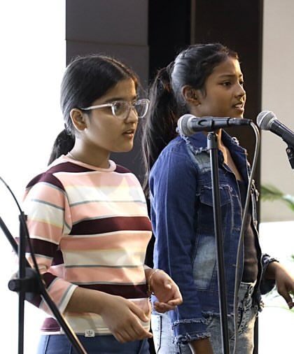 Three of our talented girl singers from the Gully Choir performing in harmony. Their dedication to music and to each other shines through in every note.