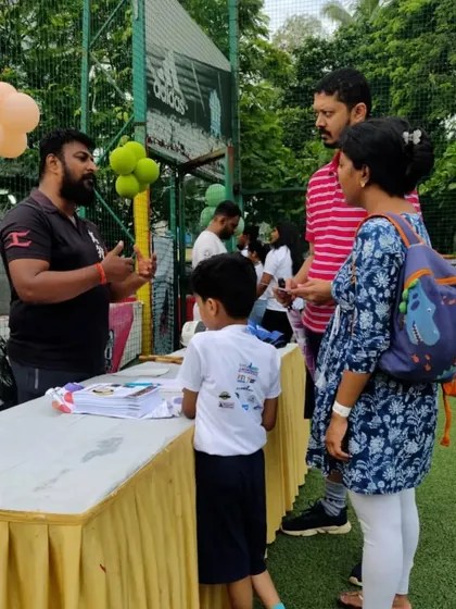 Answering questions from an interested family. Community events are a great way for me to connect with people and understand their needs.