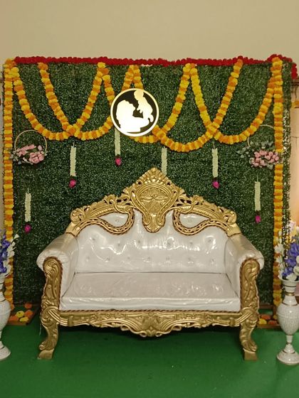 Another view of the traditional green wall setup. This versatile decoration is suitable for various family functions, providing an elegant and classic backdrop for photos.