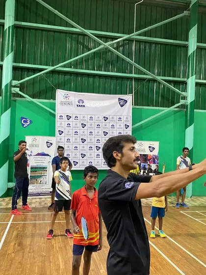 A coach demonstrates the correct grip and ready stance to a group of young players at our Gamesville special coaching camp.