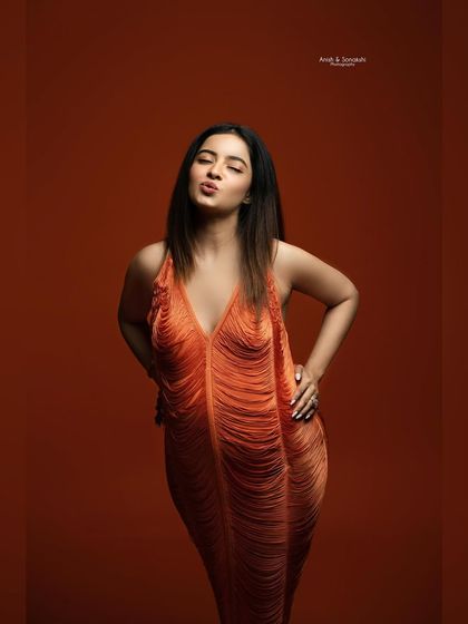 A playful and confident moment. This mama-to-be brings so much personality to her maternity session, showing that you can be both glamorous and have fun.