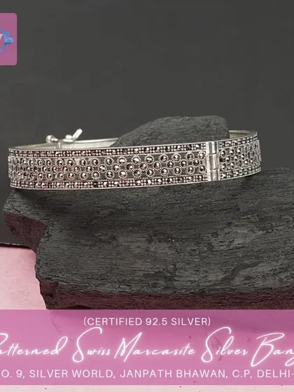 A patterned Swiss marcasite solid silver open bangle. The intricate detailing gives it a sophisticated and vintage look.