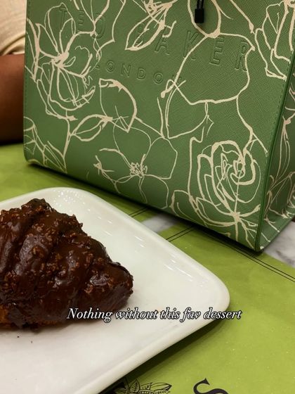 A green bag and a chocolate croissant. The perfect companions for a rainy day outing.