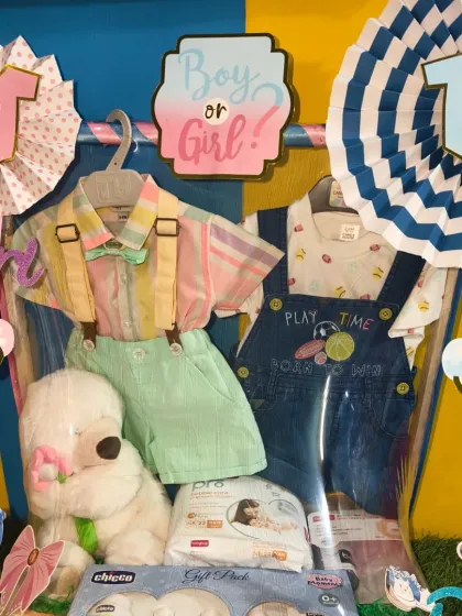 A fun 'Boy or Girl?' themed hamper perfect for a baby shower. It includes cute outfits for both, along with a soft toy and baby care products.