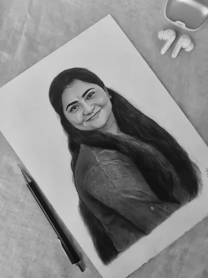 A black and white photo of the finished portrait, styled with a pencil and earbuds to create a modern, artistic flat lay.