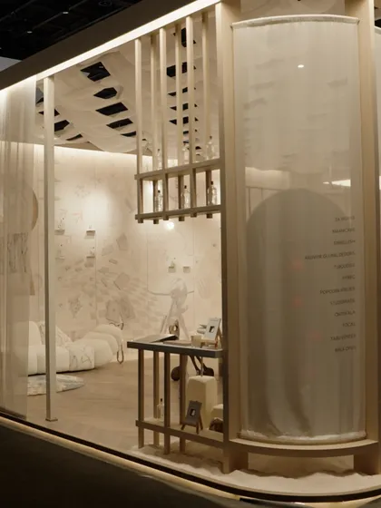 The entrance to our installation, designed to feel like stepping into another world. We used sheer, layered fabrics and a structured wooden frame to create a soft, inviting entryway that hints at the curious and playful design waiting inside.