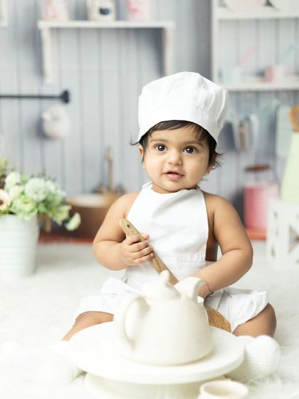 A curious little chef exploring the props in our studio kitchen.