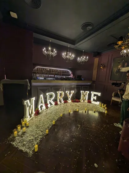 A wide angle shot showing how the proposal setup transforms the entire space. The arrangement is designed to be the main event, drawing all attention to the big question.