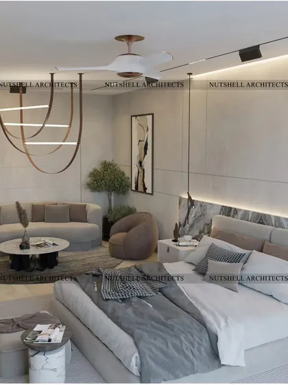Another view of the minimalist bedroom, showing the comfortable seating area with its curved sofa. The neutral color palette and clean lines create a calming and spacious feel.