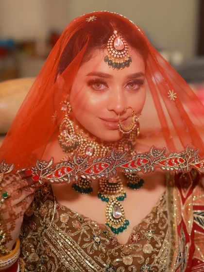 A coy glance from behind the veil. This shot is all about tradition, mystery, and the timeless beauty of a bride.