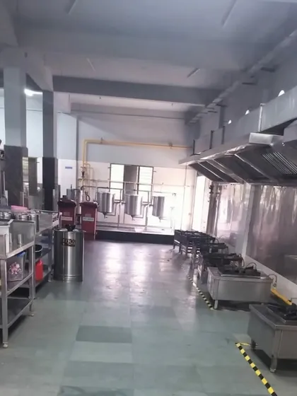 A wide view of our commercial kitchen. The layout is spacious and organized to facilitate a smooth workflow for any catering or bulk cooking operation.