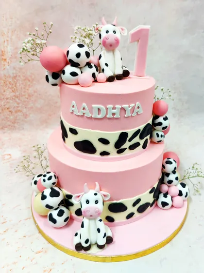 This two-tiered Pink Cow Cake is a perfect example of our charming and unique designs. Combining a playful cow print with a soft pink palette and adorable fondant cows, it showcases our ability to turn a simple theme into a sophisticated and memorable centerpiece for a first birthday.