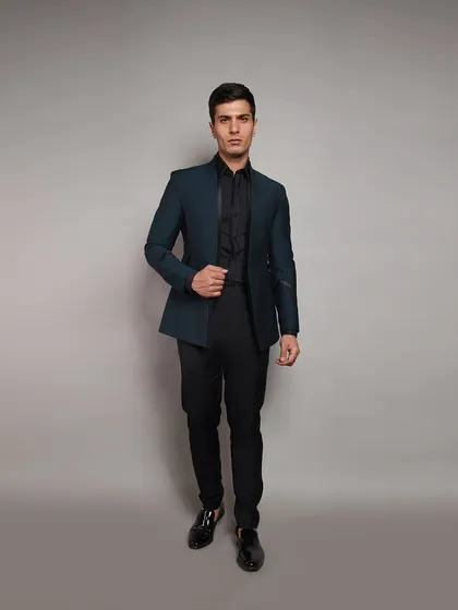 A sharp, tailored blazer in a deep teal. This piece is perfect for a reception or formal dinner, easily paired with black trousers for a sleek, contemporary look.