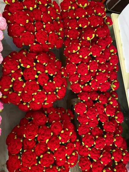 A sea of vibrant red rose heads, ready for a large bouquet or stem order.
