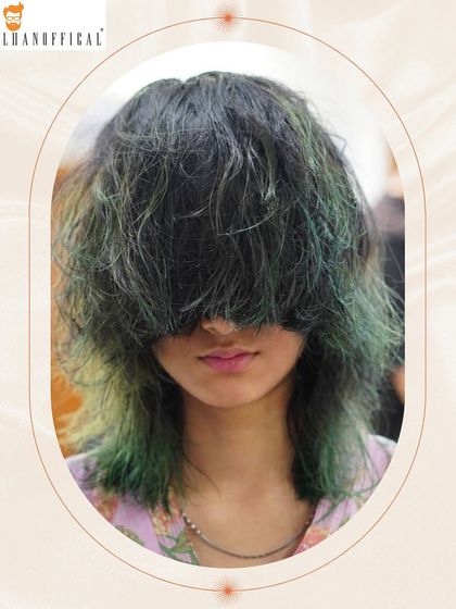 Another look at this unique green color statement. The contrast between the dark roots and the vibrant ends creates a high-impact, modern style.
