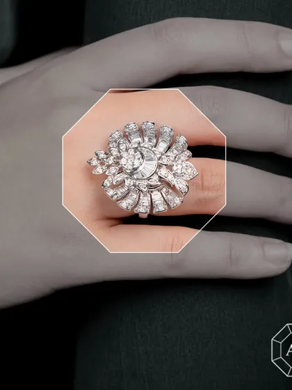 This stunning white gold statement cocktail ring features a captivating mix of round diamonds, sleek baguettes, and uniquely shaped diamonds.