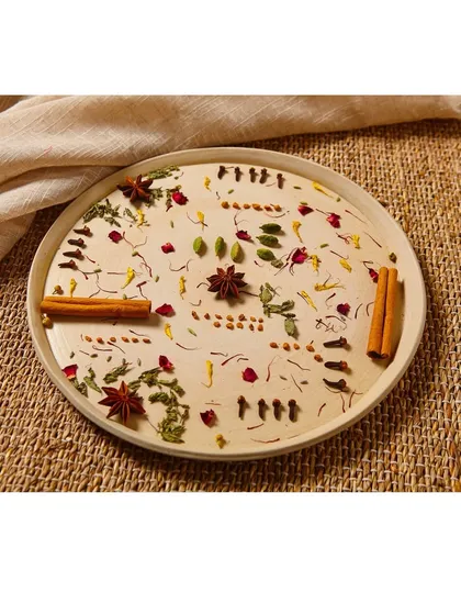 An artistic flat lay of tea ingredients like cinnamon, star anise, and rose petals. This type of shot is excellent for social media content and brand storytelling, highlighting the natural origins of the blend.