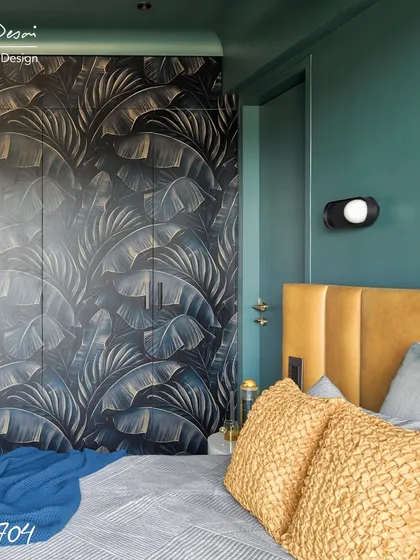 The master bedroom in Project 704 features a dramatic, custom-printed wardrobe with a tropical leaf pattern. The deep green walls and mustard yellow leather headboard create a rich, moody, and luxurious feel.