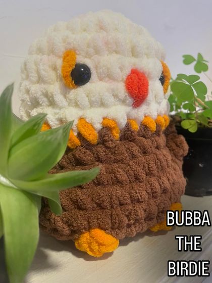 Here is another version of Bubba the Birdie, designed to look like a majestic eagle. The combination of white, brown, and orange yarn brings this powerful bird to life in a cute, cuddly form.