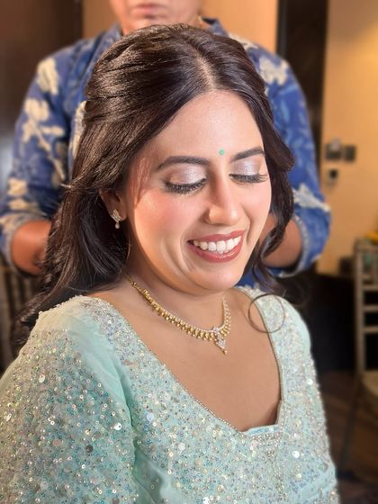 A joyful, smiling portrait, her makeup enhancing her happiness.