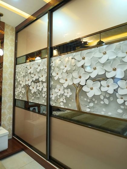 A close-up of a sliding wardrobe with a beautiful 3D floral tree design, adding a touch of artistry and elegance to the bedroom.