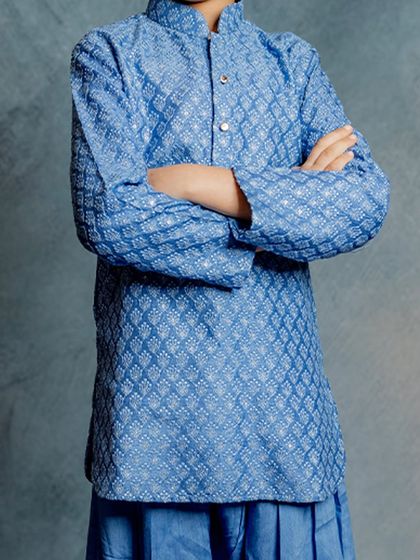 A close-up of our blue Patiala kurta, highlighting the textured fabric and classic button details. It's a simple yet elegant piece for any celebration.