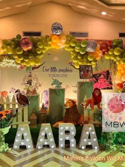 A wide shot showing the full scale of the "Our Little Sunshine" jungle-themed first birthday decoration, complete with a large elephant prop.