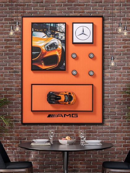 Our Mercedes AMG shadow box is a showstopper, especially against an industrial brick wall. The pop art style, vibrant orange, and 3D car model make it a perfect piece for a dining area, office, or entertainment space.