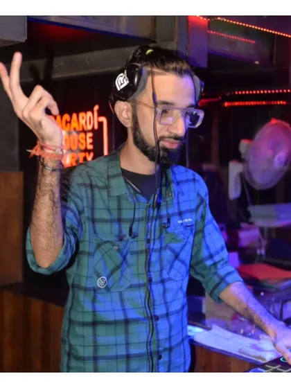Cueing up the next track during a lively set. The hand gestures are part of my performance, helping to build anticipation for the next song.