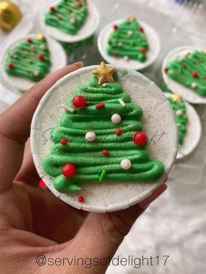 Getting into the festive spirit with these Christmas tree cupcakes. They are chocolate cupcakes topped with green buttercream trees, sprinkles, and a star.