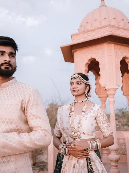 A candid-style shot of the couple on the palace balcony overlooking the water. This image has a thoughtful and cinematic quality, capturing a moment of quiet reflection during their shoot. (Duplicate of 80)