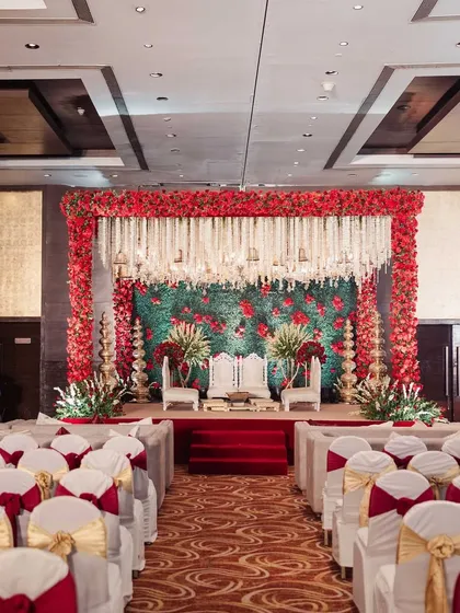 For a touch of royal elegance, I created this Sabyasachi-inspired mandap. The design features a rich palette of red florals against a green foliage wall, with traditional tuberose hangings, embodying timeless Indian luxury.