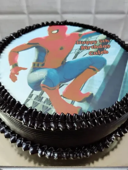 A custom photo cake featuring Spider-Man. You can personalize your cake with an edible image of any character or even your own photo.